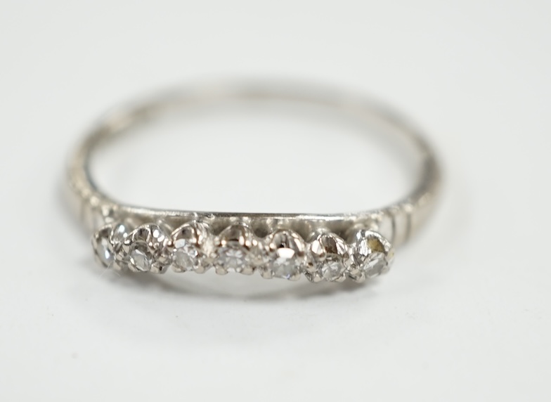 An 18ct, plat and seven stone diamond chip set 'chevron' half hoop ring, size O, gross weight 2.5 grams. Condition - fair